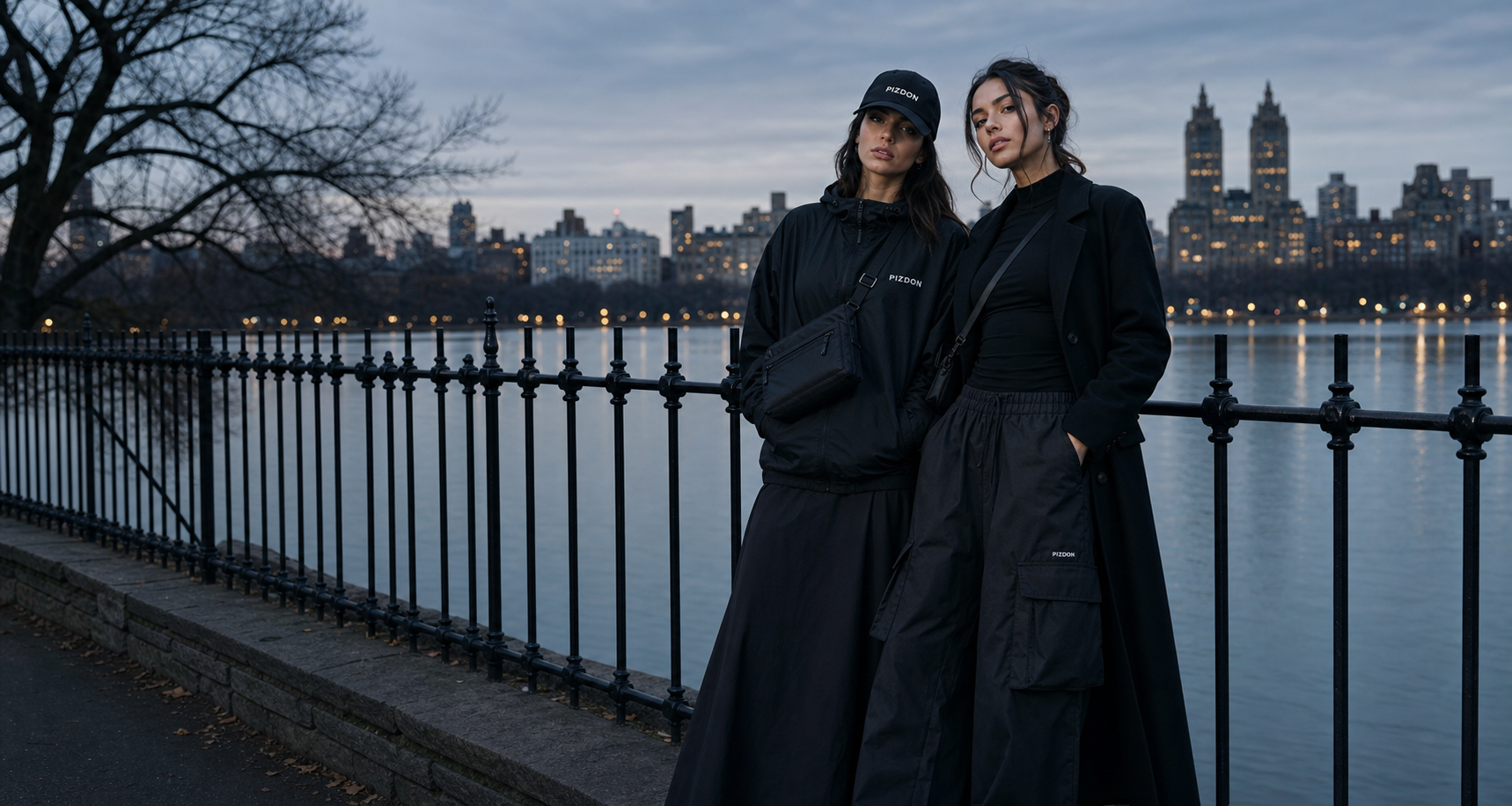 Adult PIZDON models wearing black outerwear by the Central Park reservoir